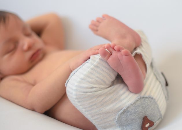 portrait of baby asleep in bed