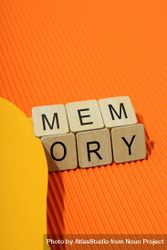 Orange duotone with the word “memory” in wooden blocks, vertical 0vZM70