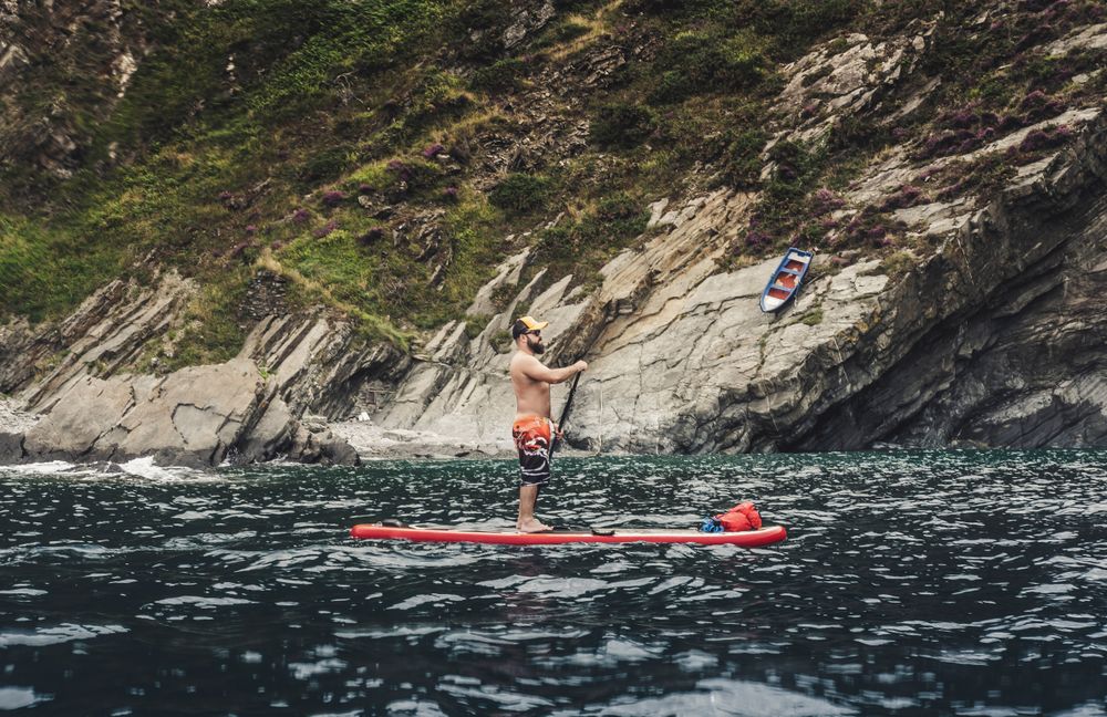 Man on paddleboard floating in sea