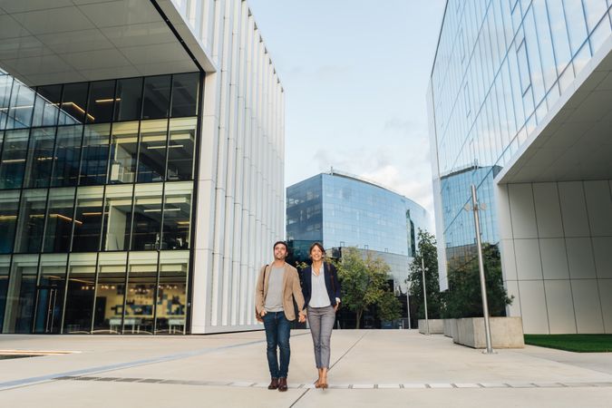 Businesspeople couple outside contemporary building
