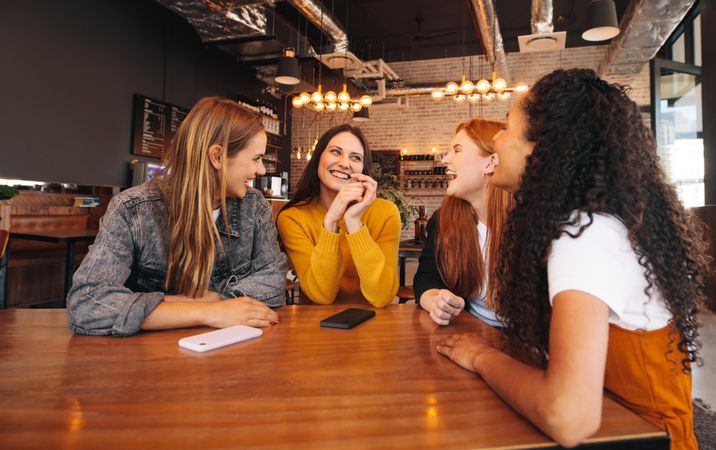 Group of female friends meeting in a coffee shop