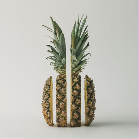 Split pineapple on light background