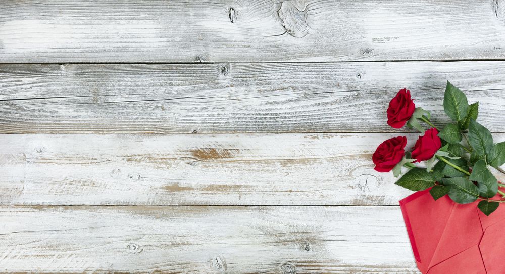 Valentine’s day with gifts and letter on rustic wood