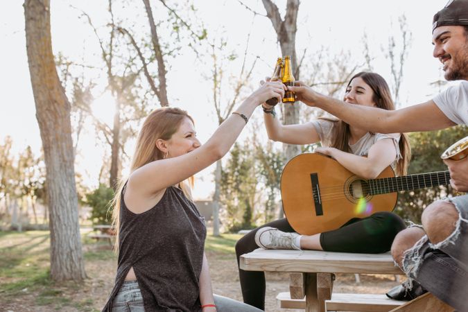 Young musicians drinking beer in park