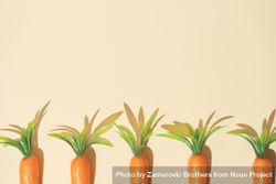 Row of carrots on pastel yellow background 0Wx6r5