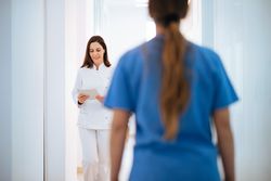Doctor in white uniform walking along corridor