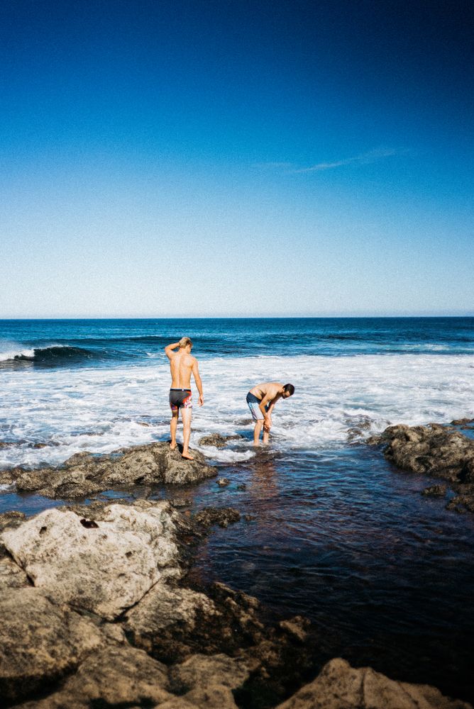 Two men standing in the ocean