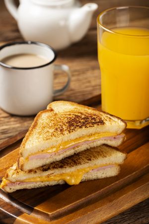 Grilled ham and cheese. Sandwich with cheese and ham on grill.