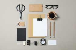 Mockup. Corporate stationery, glasses and alarm clock on grey background. Flat lay