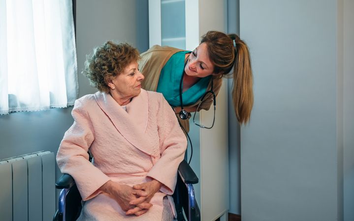 Doctor talking to patient in a wheelchair