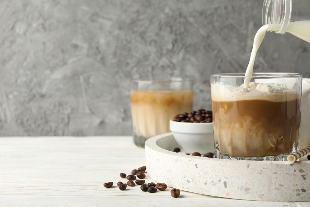 Composition with tray with ice coffee on wooden background