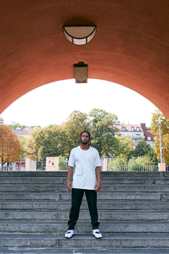 Trendy Black man near modern arch