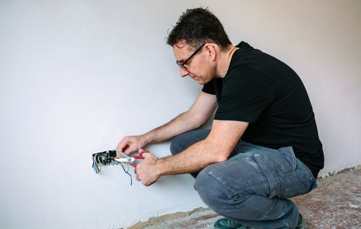Electrician working on the electrical installation of a house