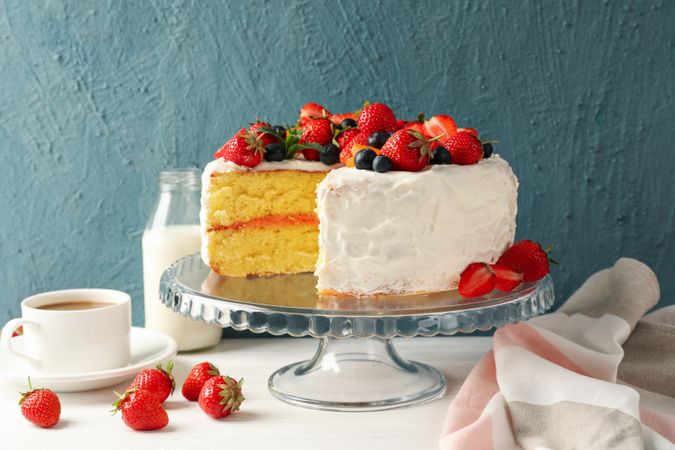 Composition with delicious berry cream cake on wooden table. Tasty dessert