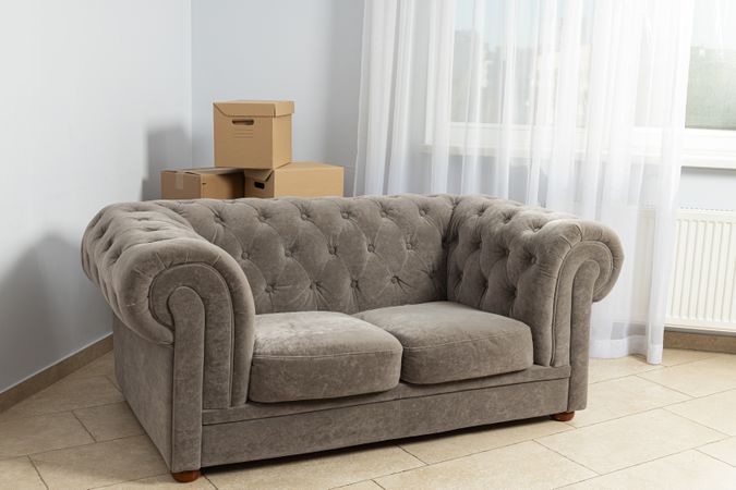 Moving concept, sofa and things in boxes