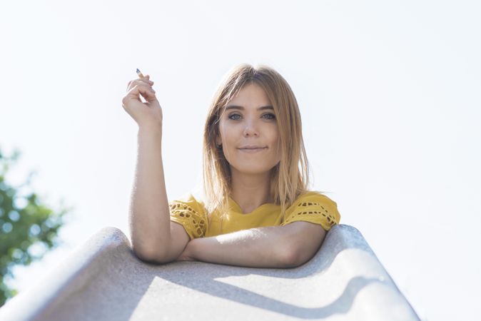 Young woman holding cigarette