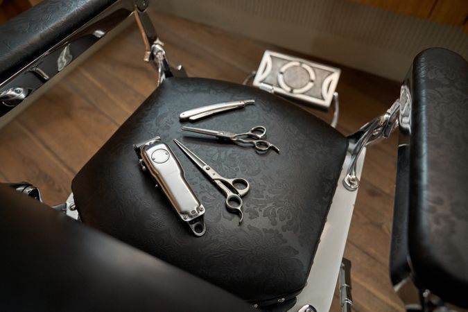 Hairdressing tools on leather chair in barbershop