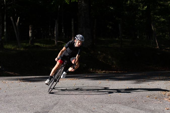 Professional cyclist riding bike in park