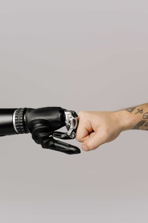 Robot and person's hand fist bump