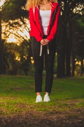 Crop sportive woman standing on meadow