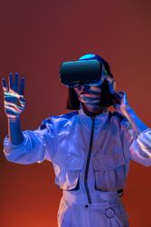 Woman touching air in VR glasses