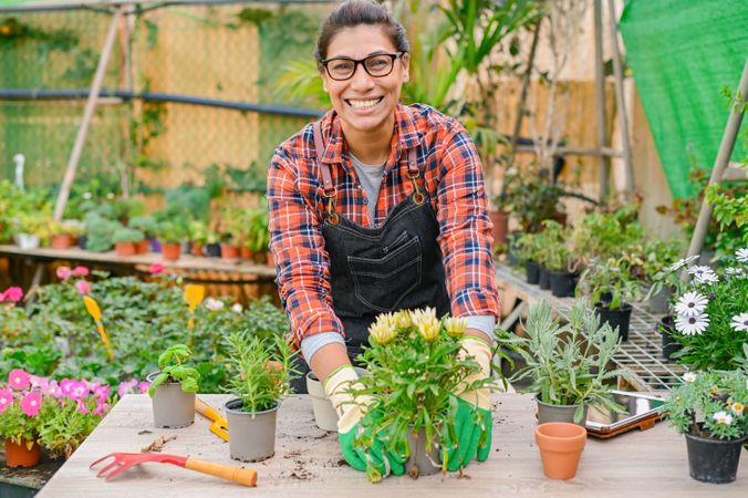 Cheerful gardener working with plants