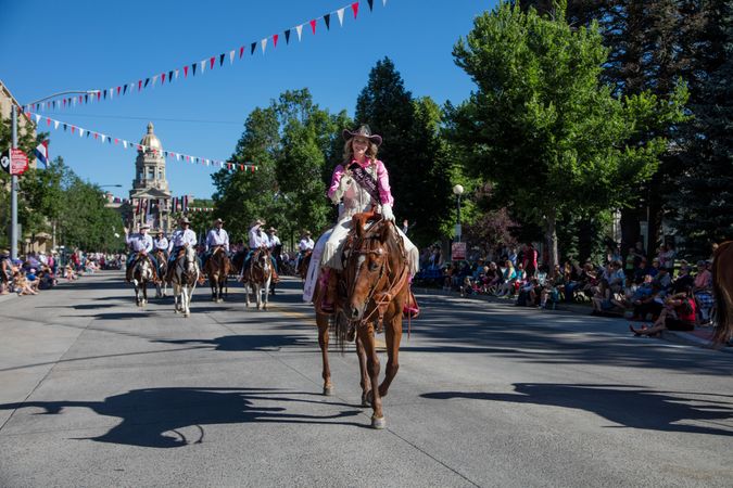 Woman riding horse back during a parade during Cheyenne Frontier Days, Wyoming