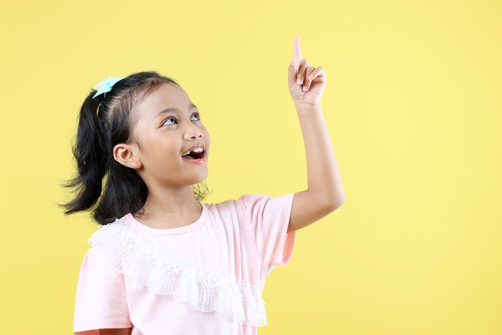 Asian Girl AHA Great Idea Concept on Yellow Background