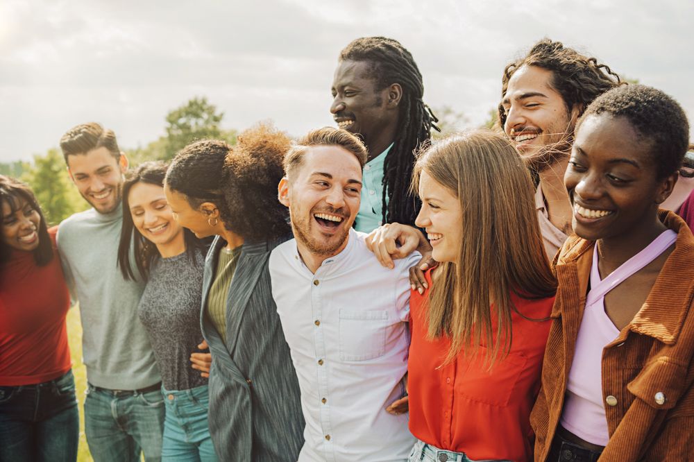 Group of young friends of different races and cultures having fun together outdoors