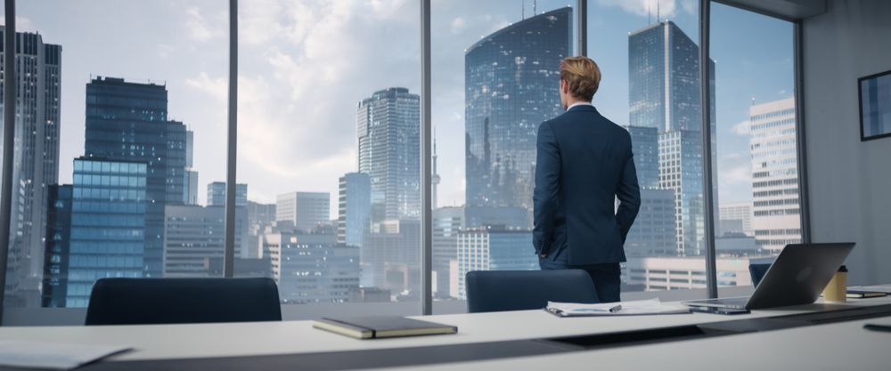 White Businessman Entering His Corner Office With Big City Megapolis View.