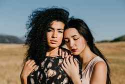 Female friends standing in field
