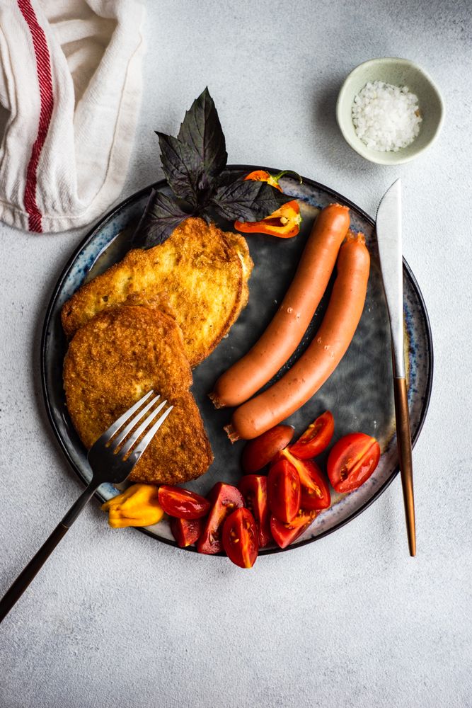 Top view of sausage dinner with toast on a plate