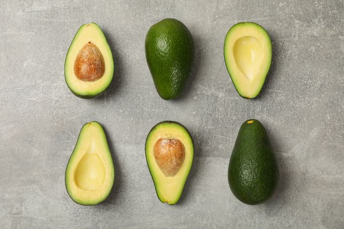 Flat lay with avocado on gray background, top view