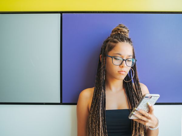 Woman with dreadlocks in glasses taking selfie