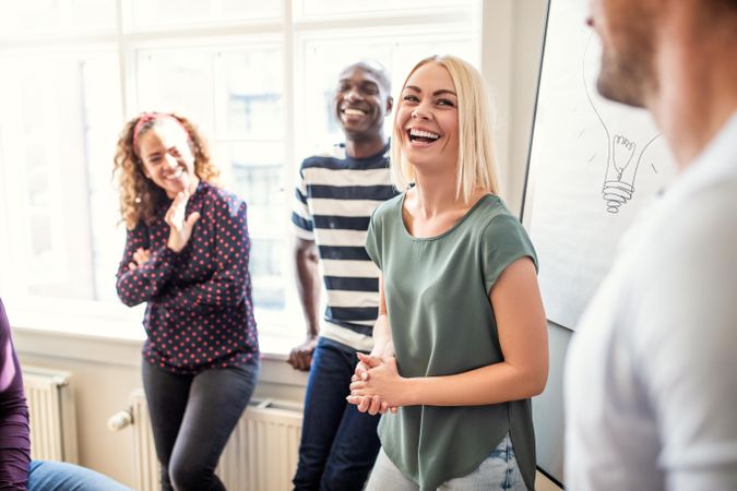 Group of people smiling during a presentation