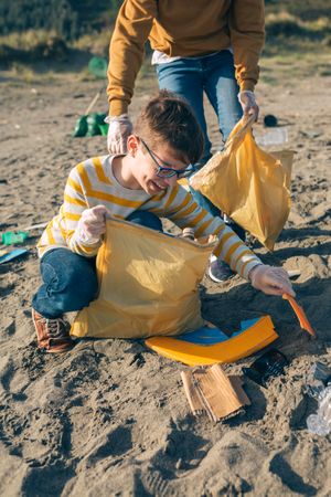 Young volunteers cleaning the beach