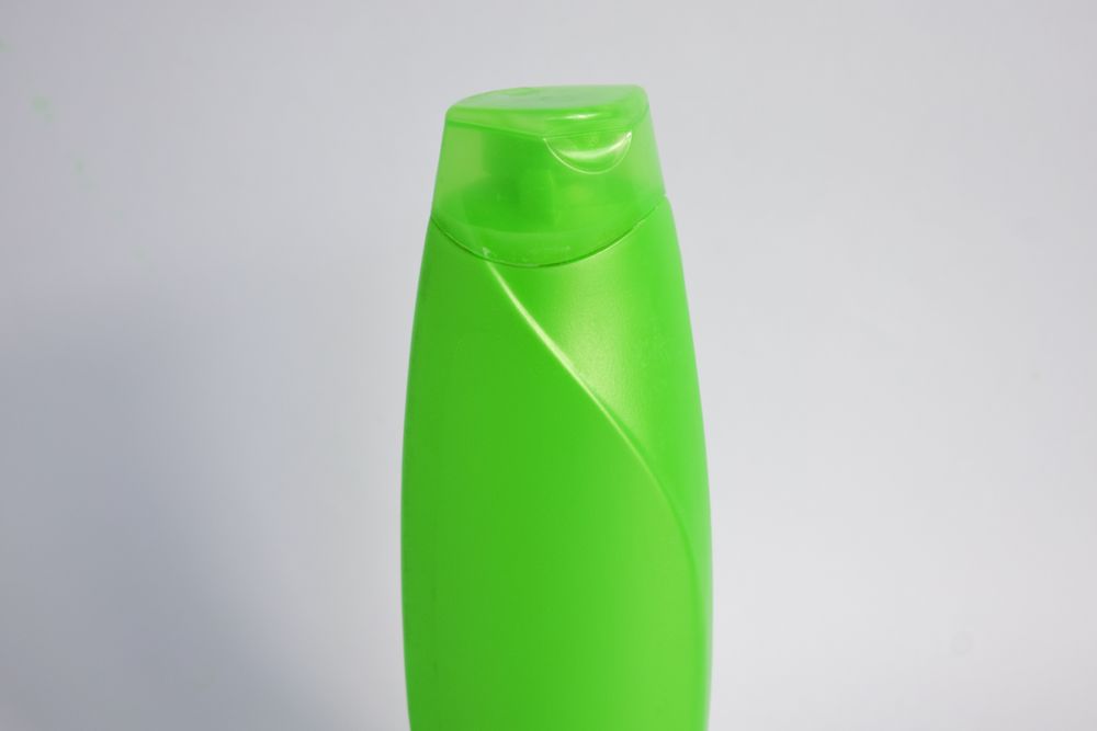 Green mockup shampoo or body wash bottle with copy space