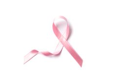Pink awareness ribbon isolated on blank background, top view