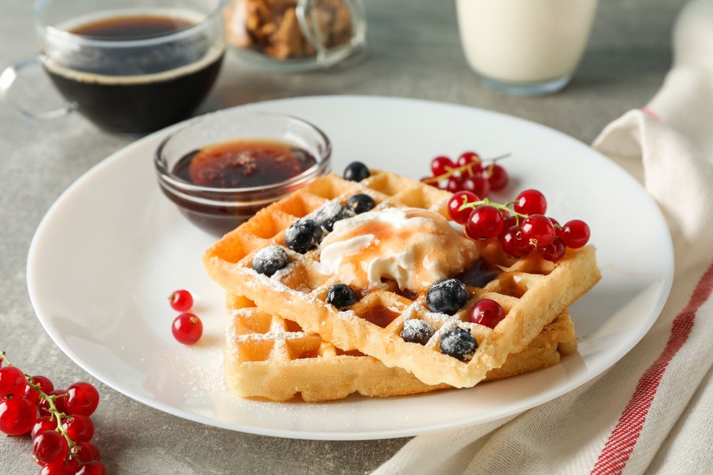 Composition of breakfast with belgian waffles, space for text