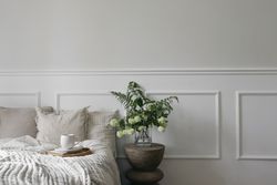 Bed with tray of coffee and vase with flowers