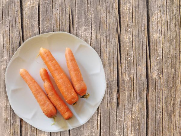 Carrots On The Wooden Background