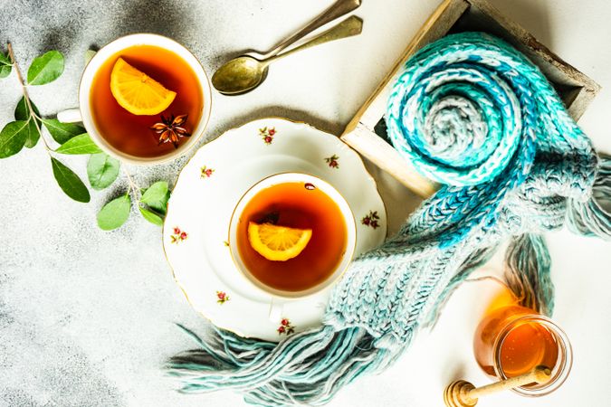 Top view of cosy table with tea in cup and saucer on counter