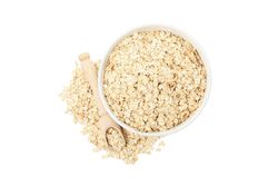 Bowl and scoop with oatmeal flakes isolated on plain background