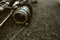 Fishing reel with fishing line on ground