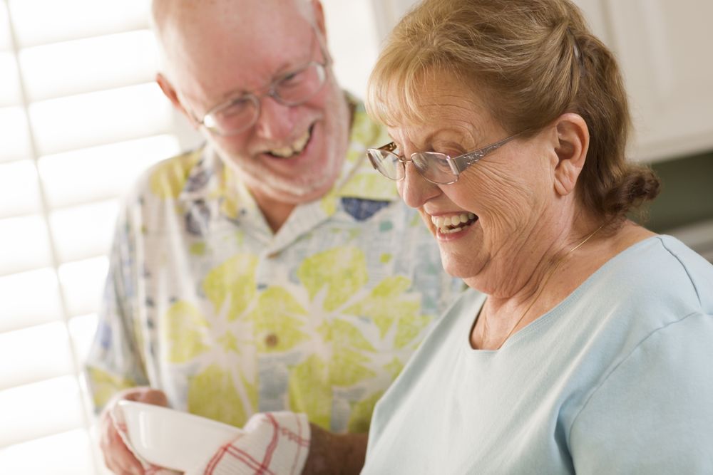 Adult Couple Washing Dishes Together Inside Kitchen