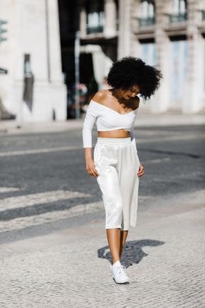 Young stylish female walking outdoors