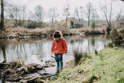Young girl walking around a marsh