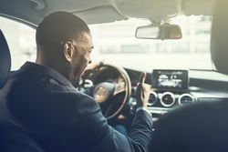 Shot of man driving and giving the thumbs up from driver seat