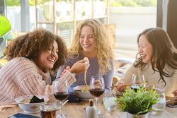 Laughing friends having fun in restaurant