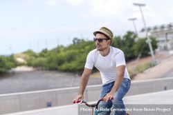 Male in hat having a relaxing bicycle ride outside 5X9eM4